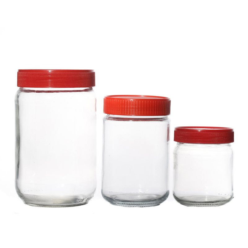 Vente chaude boisson en verre personnalisé pour miel de verre en verre d'emballage alimentaire avec couvercles rouges en plastique